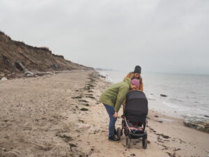 Familie am Strand mit Kinderwagen
